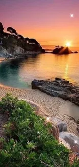 Serene sunset at a rocky beach with vibrant sky and calm ocean.