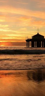 Serene sunset over beach with orange sky and calming waves.