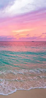 Calm beach during pink and blue sunset with gentle waves.