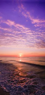 A serene beach with a vibrant purple sunset over the ocean waves.