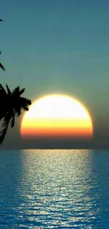 Tranquil beach sunset with palm silhouettes against a vibrant blue sky and ocean.