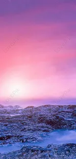 Pink and purple sunset beach wallpaper with rocky shore and ocean.