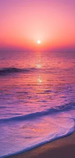 Purple sunset over a tranquil beach with gentle waves.