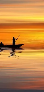 Silhouetted boat at sunset on calm, reflective water.