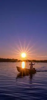 A peaceful sunset over water with a silhouette of a boat and golden sun.