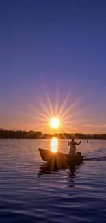 Silhouette of a boat during a stunning sunset over calm waters.