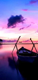 Serene boat under a vibrant sunset sky.