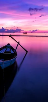 A small boat on calm waters at sunset, reflecting vibrant purple and blue hues.