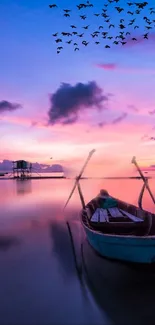 Boat on tranquil water at sunset with birds in sky.