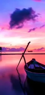 A serene sunset with a boat silhouetted on calm pink waters.