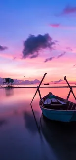 Solitary boat on calm waters at sunset with vibrant sky reflecting purples and pinks.