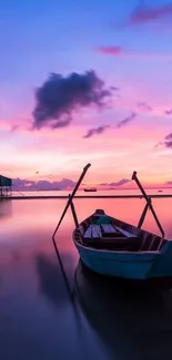 Serene sunset boat on calm sea with pink and blue sky.