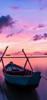 Tranquil scene with a boat under a vibrant sunset sky.