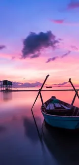 A serene sunset with a boat on calm waters under a pink and purple sky.