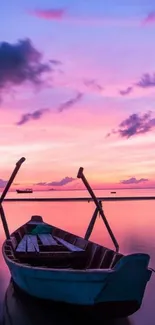 Peaceful boat on tranquil sea during vibrant sunset.