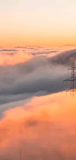 Sunset cloudscape with an industrial tower emerging through softly colored peach clouds.