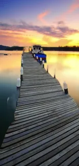 Wooden dock stretching into a serene sunset over calm waters.