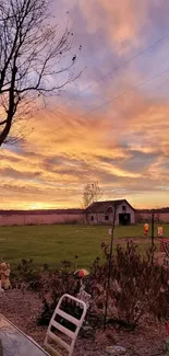 Serene farm landscape at sunset with vivid sky.