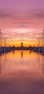 Serene harbor at sunset with boats reflected in calm water.