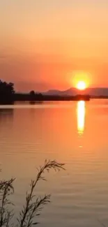 Serene sunset over lake with reflection.