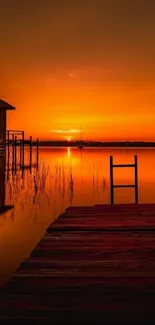 Serene sunset over a tranquil lake with a wooden dock.