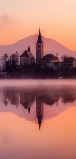 Serene sunset over a reflective lake with a church silhouette.