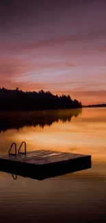 Calming sunset over a serene lake with a dock silhouette.