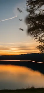 Serene sunset over a lake with orange hues.