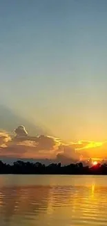 Serene sunset over a calm lake with vibrant skies.