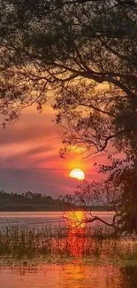 Serene sunset over a tranquil lake with vibrant orange hues.