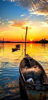 Boat on a serene lake during sunset with vibrant orange hues.