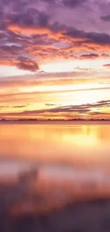 Peaceful sunset over a calm lake with purple and orange tones.