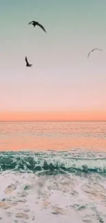 Ocean with birds flying at sunset under a pastel sky.