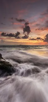 Vibrant sunset over ocean with waves crashing on rocks.