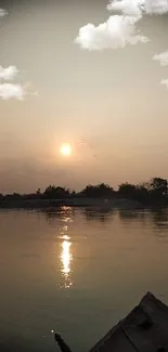 Serene sunset over calm waters with a boat in the foreground.