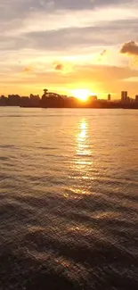 Beautiful sunset view over a city skyline with golden reflections on the ocean.