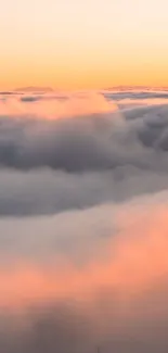 Beautiful sunset view over fluffy clouds with a pastel glow.