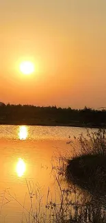 Serene sunset over a tranquil lake with golden reflections.