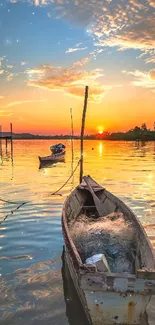 Sunset over lake with a boat and calm waters, creating a serene mobile wallpaper.