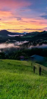 Vibrant sunrise over green hills with misty clouds.