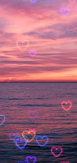 A serene sunset over the ocean with vibrant pink and purple hues.