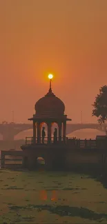 Sunset view with temple on riverbank.