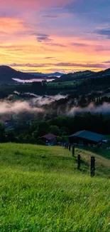 Beautiful sunset over green hills and misty landscape, perfect for mobile wallpaper.