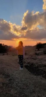 Sunset over hills with glowing sky and serene landscape.