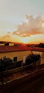 Orange-hued sunset over suburban rooftops.