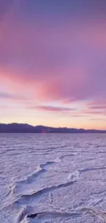 Beautiful sunset over salt flats with pink sky.