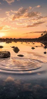 Serene sunset reflection on calm water with rocks and trees silhouetted.