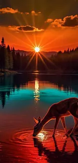 Deer by a lake with a stunning sunset behind.