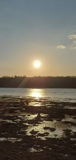 Serene sunset over calm water with clear sky.