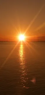 Beautiful sunset over calm ocean with golden reflections.